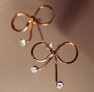 Golden Bow on Diamond Earrings